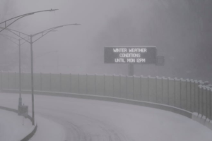 Freeway weather sign stating winter weather conditions until Monday 12PM.