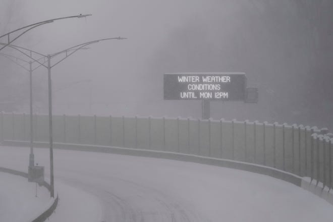 Freeway weather sign stating winter weather conditions until Monday 12PM.