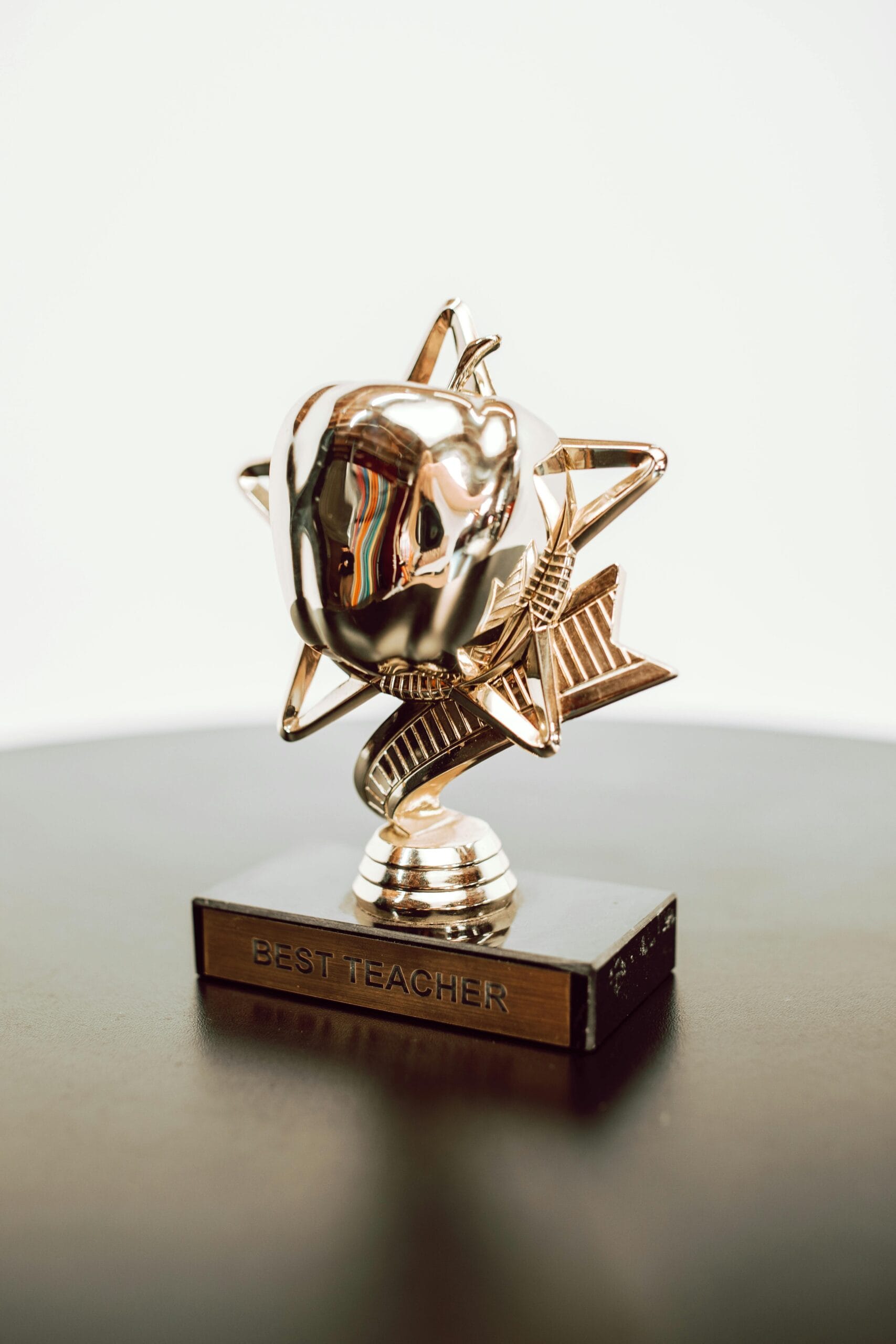 Best teacher trophy, golden in color in the shape of an apple sitting on a star